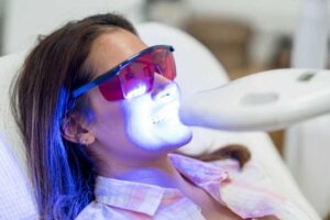 Cosmetic Dentist performing Laser Teeth Cleaning